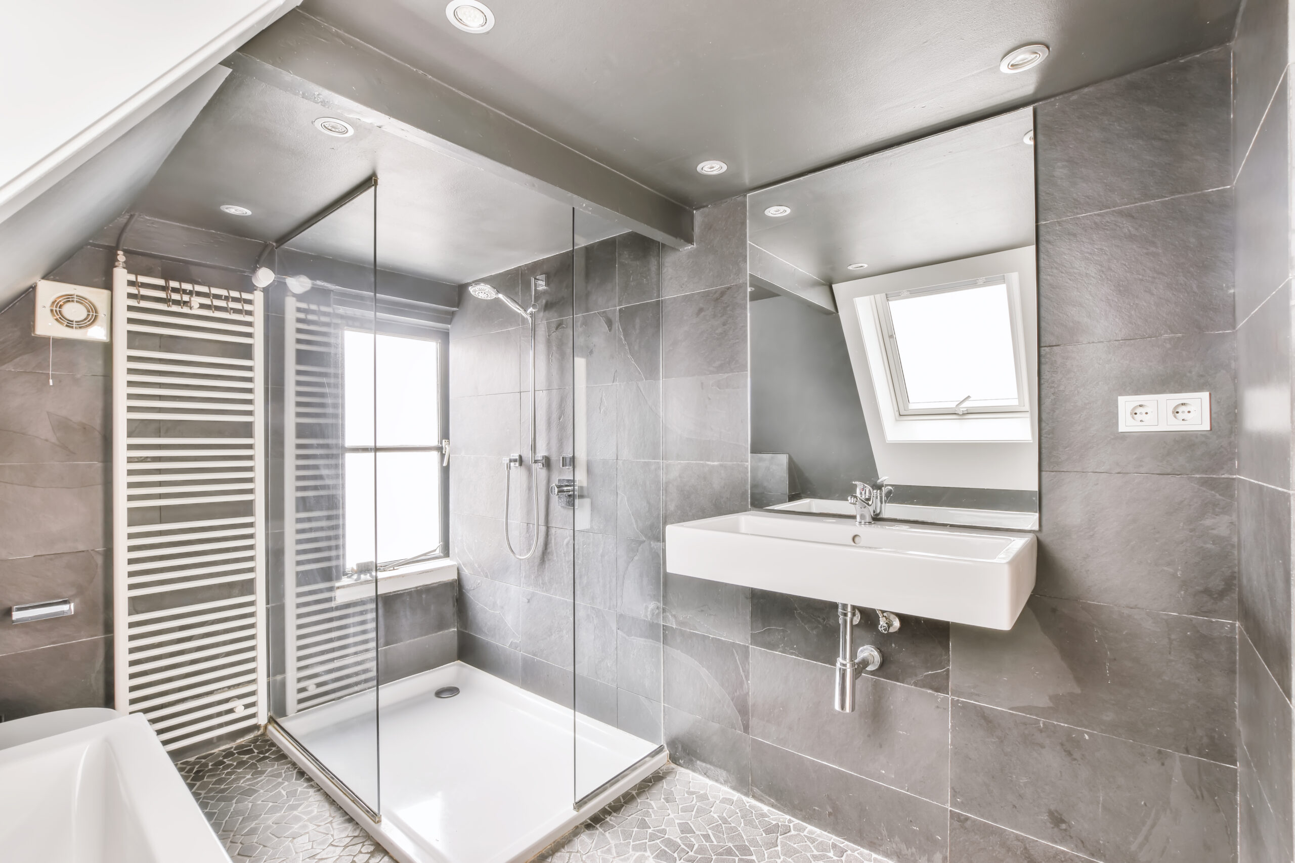 Luxurious bathroom in gray colors with a window on the wall